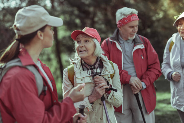 Elderly woman talking to the guide while hiking