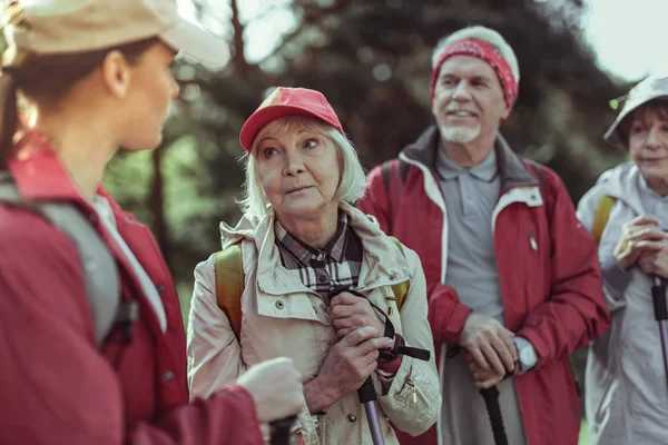 Emotional elderly woman listening to the hiking guide — Stock Photo, Image