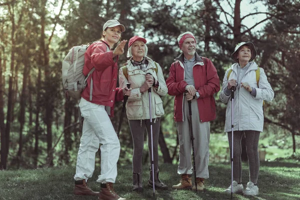 Guide showing tourists a sights while hiking