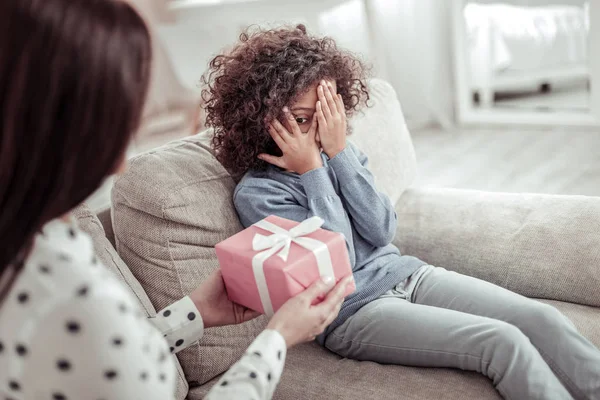 Careful attentive mother presenting a nice gift to a girl — Stock Photo, Image