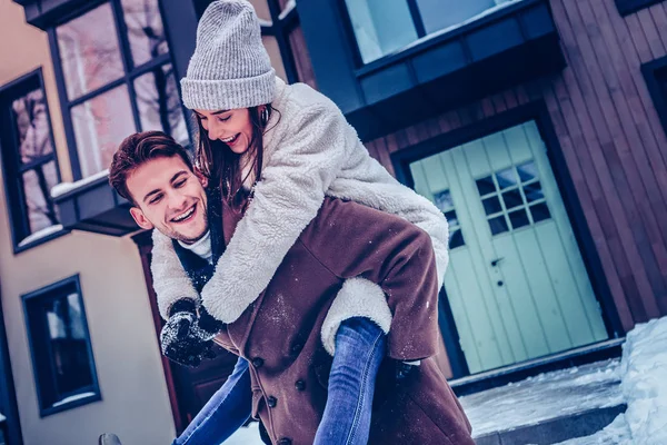 Husband wearing brown coat caring his woman in hands — Stock Photo, Image