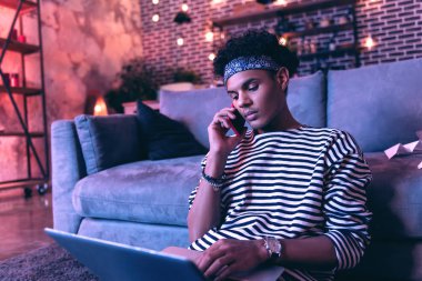 Burnunun üstünde a laptop tutmak ve katta oturan ev ödevi hakkında arkadaşıyla danışmanlık Afro-Amerikan teen.