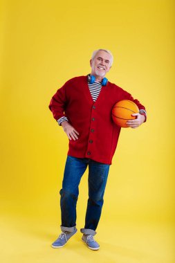 Heyecanlı hissediyorum Modern emekli adam basketbol topu tutan