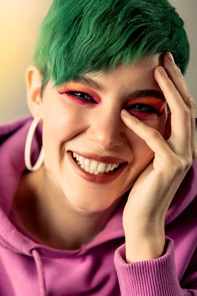 Portrait of a happy young woman touching her face — Stock Photo, Image