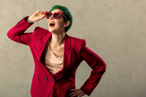 Delighted cheerful young woman touching her sunglasses — Stock Photo, Image