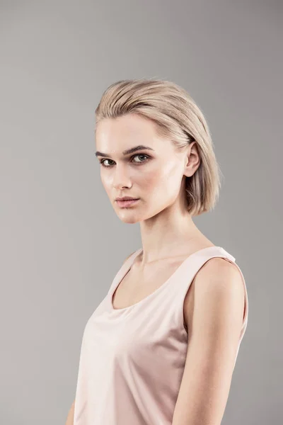 Thin young lady looking serious during photoshoot — Stock Photo, Image