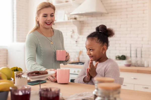 Söt dotter känsla upphetsad att få kopp te på morgonen — Stockfoto