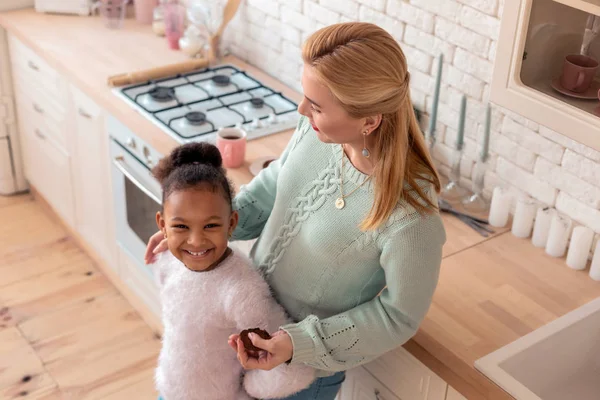 Cute daughter smiling while spending day with her mother — Stock Photo, Image