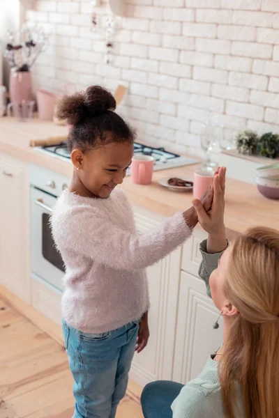 Cheerful funny girl giving high five to her loving mother — Stock Photo, Image