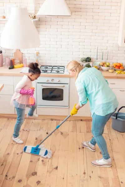 Vista superior de la madre y su hijo adoptivo limpiando la cocina —  Fotos de Stock