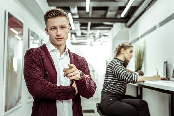 Good-looking guy with tidy haircut wearing burgundy cardigan