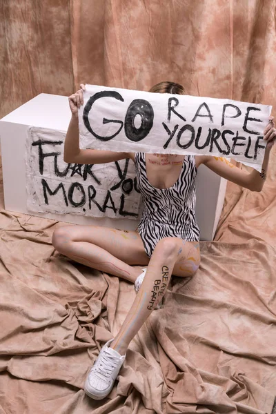 Nice young woman holding a sign with inscription — Stock Photo, Image