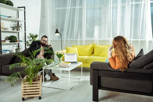 Serious bearded practitioner listening to his visitor — Stock Photo, Image