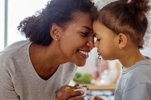 Närbild på curly-haired kvinna att titta på sitt barn — Stockfoto