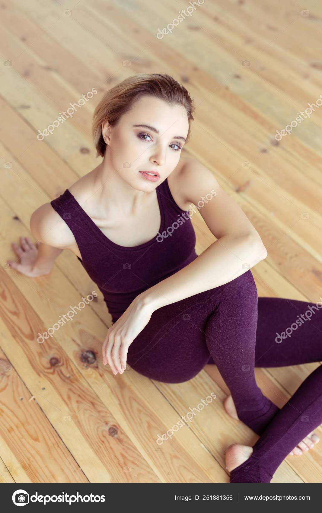 Blonde Short Haired Woman Sitting In Closed Posture And Showing