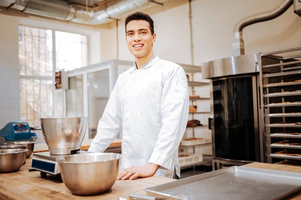 Chef brun portant un uniforme blanc debout dans la cuisine — Photo