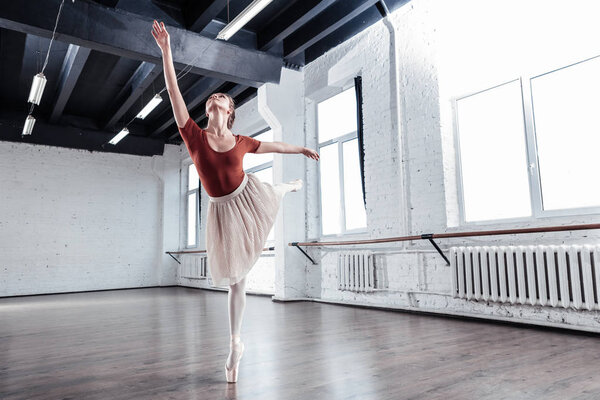 Beautiful young woman training in the dancing hall