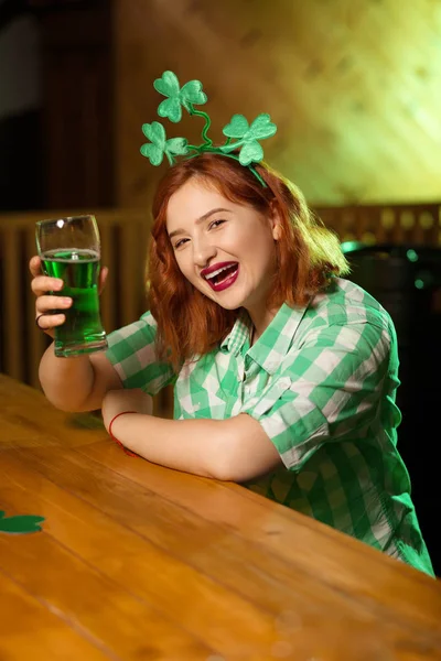 Red-haired pretty girl with shamrock headwear smiling happily — Stock Photo, Image