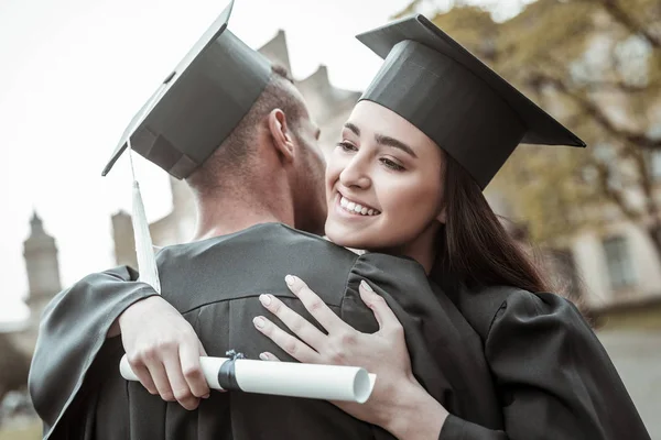 Positive delighted brunette girl embracing her friend — Stock Photo, Image