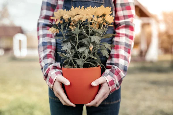 Girl in fashion t-shirts showing how growing her flowers