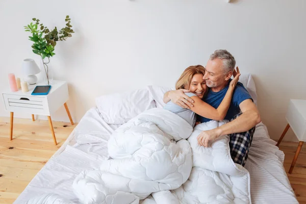 Fröhlich strahlende Ehefrau umarmt ihren starken unterstützenden Mann — Stockfoto