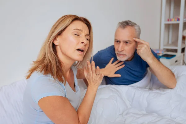 Blonde-haired wife feeling tired of her husband making excuses — Stock Photo, Image