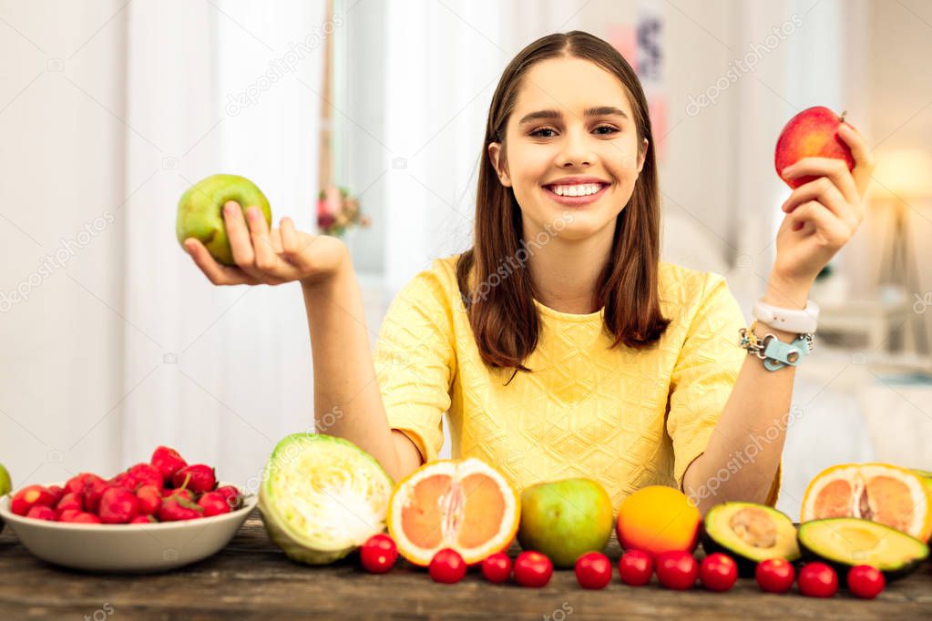 Smiling young woman eating various healthy food