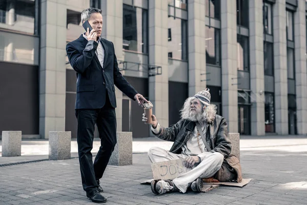 Thankful grey-haired senior homeless looking on business man — Stock Photo, Image