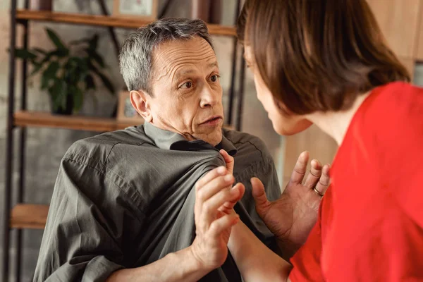 Dark-haired mad woman using force during argument with her man — Stock Photo, Image