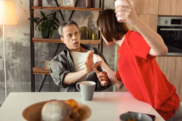 Scared and shocked man stopping his crazy wife — Stock Photo, Image