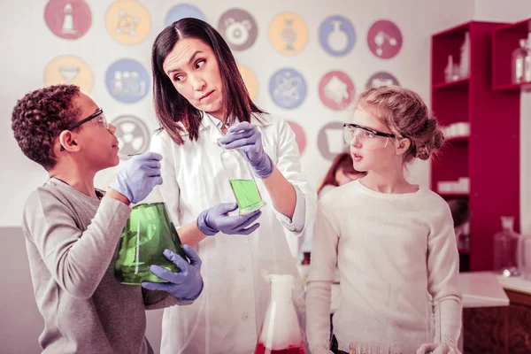 Attentive teacher looking on her student with weird face expression — Stock Photo, Image