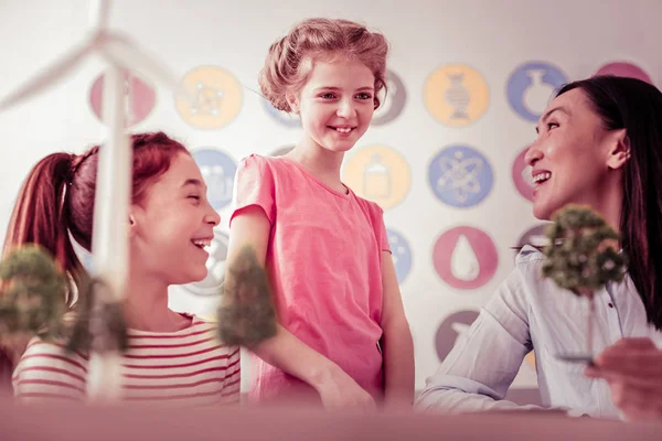 Shy cute schoolgirl looking on the model of the farm — Stock Photo, Image