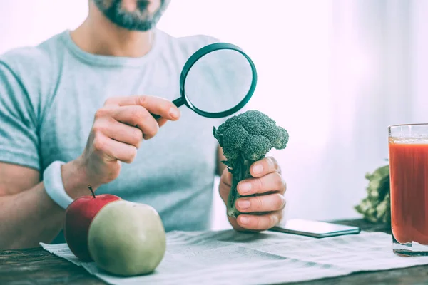 Motivated interested man learning different types of vegetables