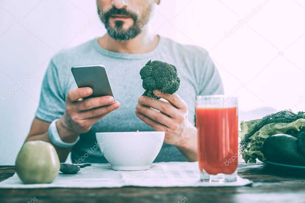 Modern nice man holding broccoli in the hand