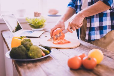 Heyecanlı adam mutfakta bir vejetaryen yemek pişirme