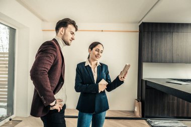 İç mekan tasarımcısı üzerinde mavi ceket bazı renkler mutfak için sunan