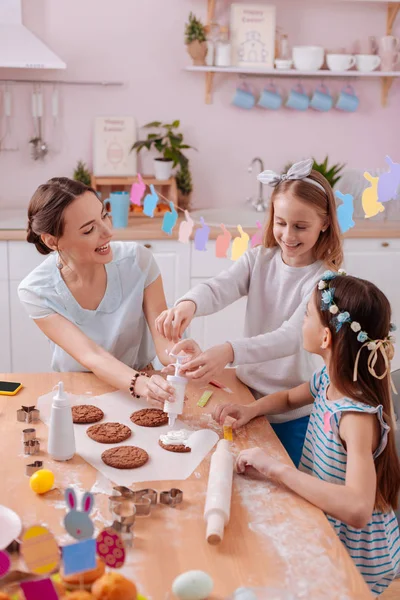 Las mujeres alegres adornan las galletas junto con el placer — Foto de Stock