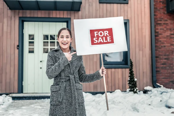 Woman feeling excited selling her house while moving to boyfriend