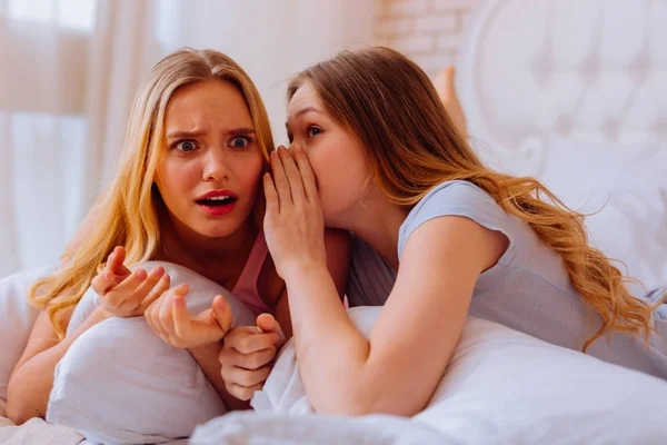 Older sister feeling shocked after hearing news from sibling — Stock Photo, Image