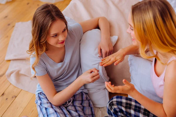 Sisters wearing pajamas deciding where to go at the weekend — Stock Photo, Image