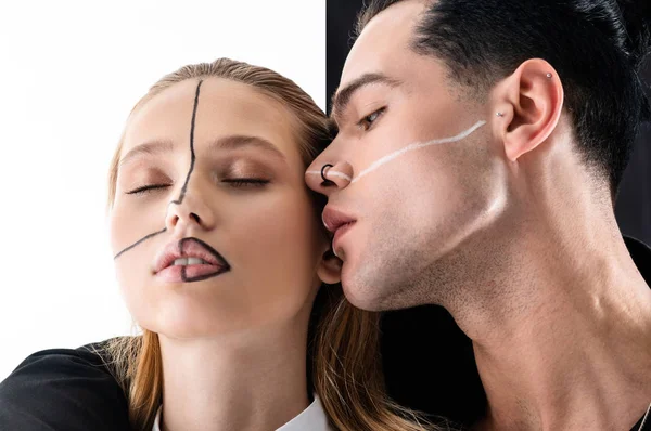 Good-looking models posing with black and white lines on faces — Stock Photo, Image