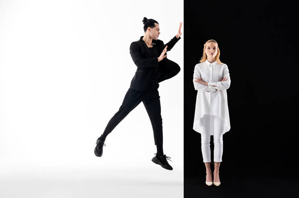 Male model wearing black suit and female model in white posing