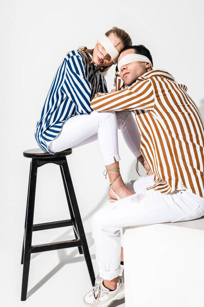 Model leaning on strong man while working for promotion