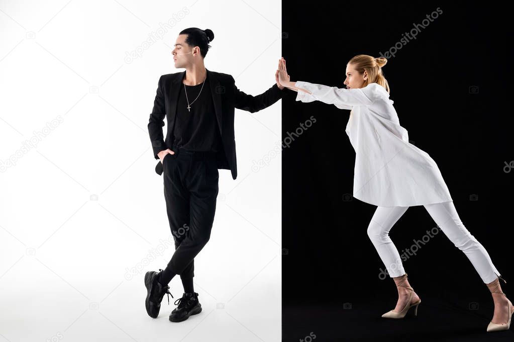 Man with hair bun not looking at his woman in white