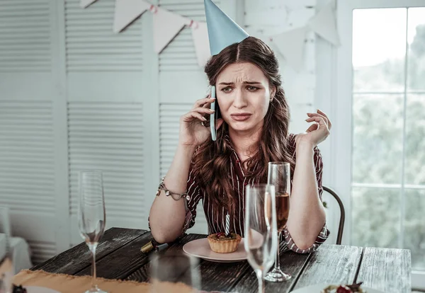 Crying woman phoning to her friend on her birthday — Stock Photo, Image