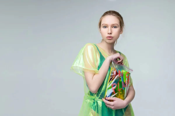 Model posing for no plastic campaign near the grey background