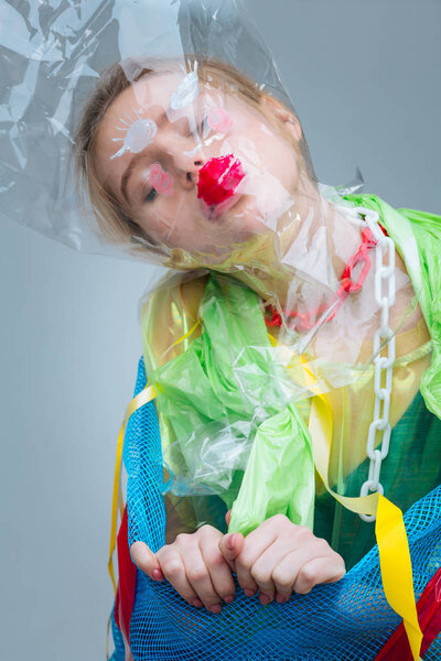 Model wearing plastic bag on face taking part in ecology photo shoot