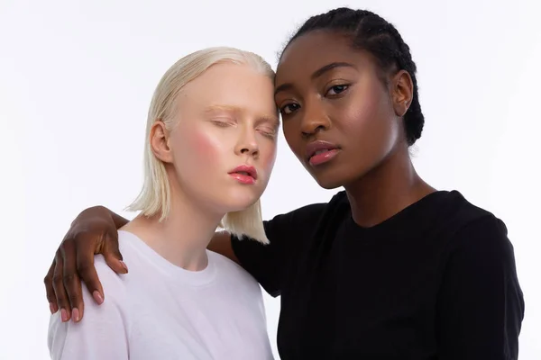 African-American woman hugging woman with white skin — Stock Photo, Image