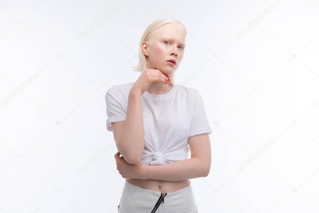 Skinny model with bob cut wearing skirt and short t-shirt