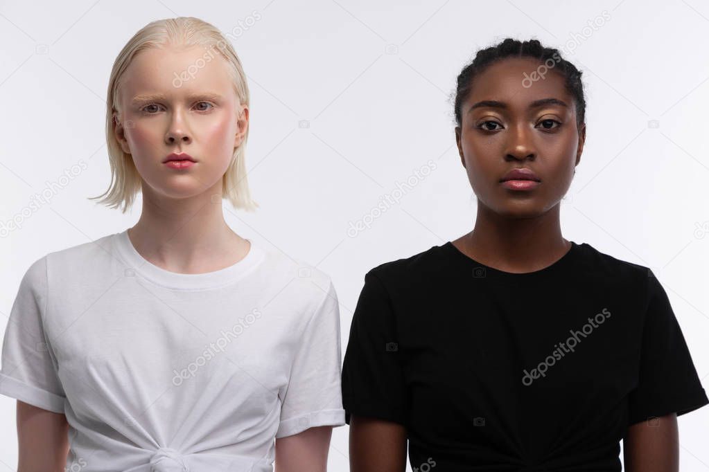 Equal women with different appearance standing near each other